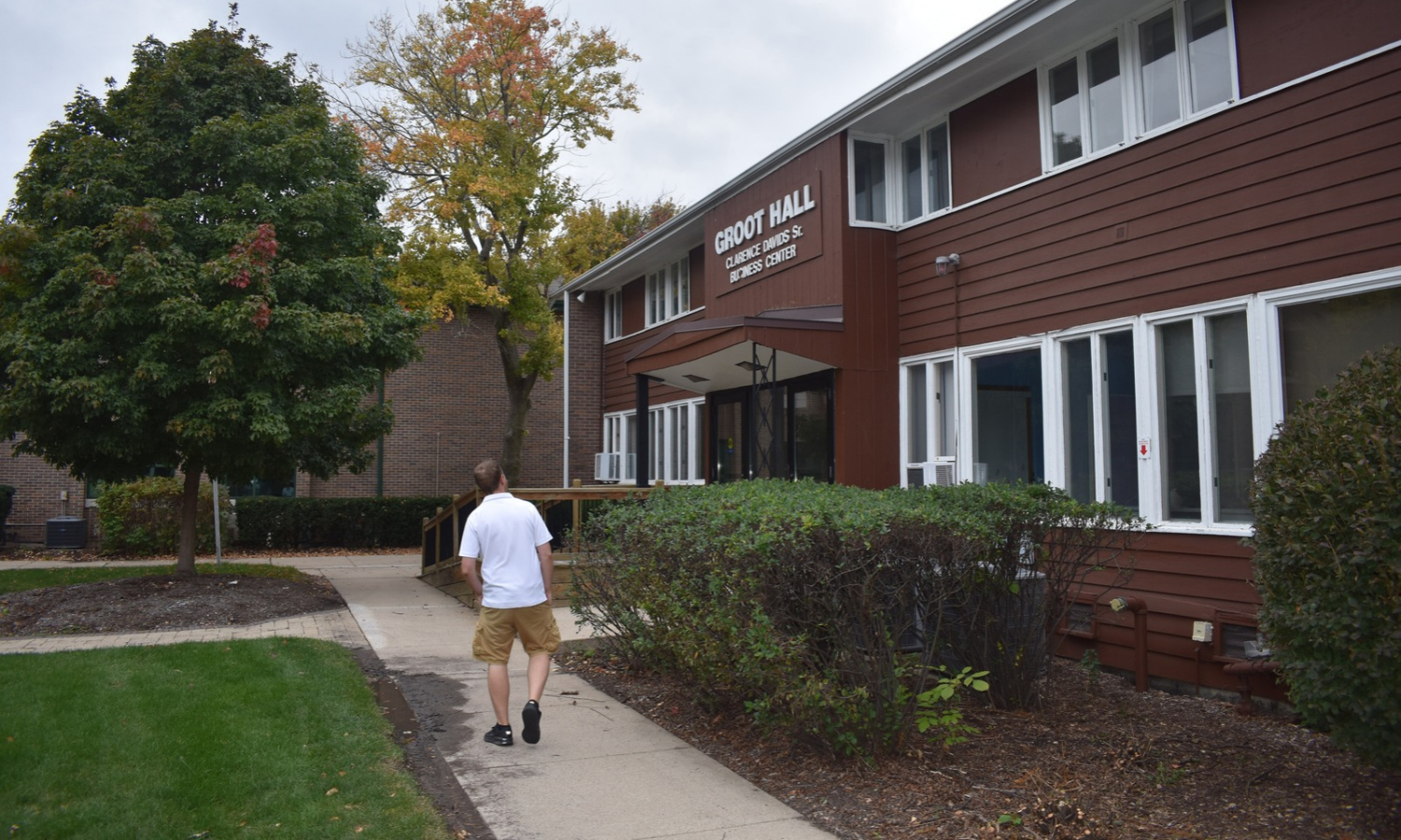 Building exterior with a person walking toward the entrance